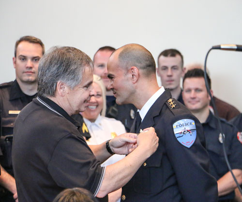 Former Tulalip Police Chief, Jay Goss, pins newly appointed Police Chief Carlos Echevarria during the swearing in ceremony held May 7, in the Tulalip Tribes Board Room. Photo/ Brandi N. Montreuil, Tulalip News