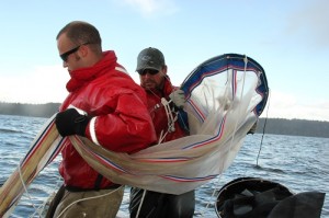 Jed Moore and Emiliano Perez, Nisqually natural resources staff, deploy a plankton net in deep South Sound.