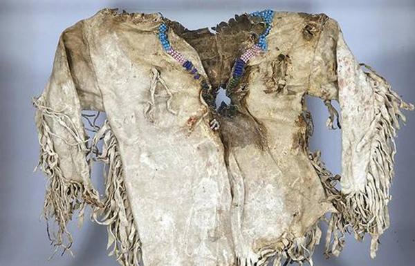 source: Waddington's, via theglobeandmail.comLot 22 - 'Northern Plains Indian Child's Tunic, early 19th century fringed and with beaded collar, showing signs of central bullet trauma.'