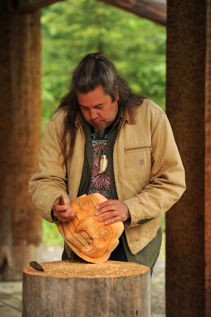 Master carver Tommy Joseph works on a helmet at the Alaska Native Heritage Center, Friday May 30, 2014. Known for his totems, he has recently done research on Tlingit armour.Master Carver Tommy Joseph from Sitka is in town doing workshops at the southeast site at the Alaska Native Heritage Center. He'll give a talk at the Anchorage Museum on June 5. He's famous for his totems, but has done a lot of research on Tlingit armor, which will be the subject of his talk. He's working on a helmet right now. ANNE RAUP — Anchorage Daily News 