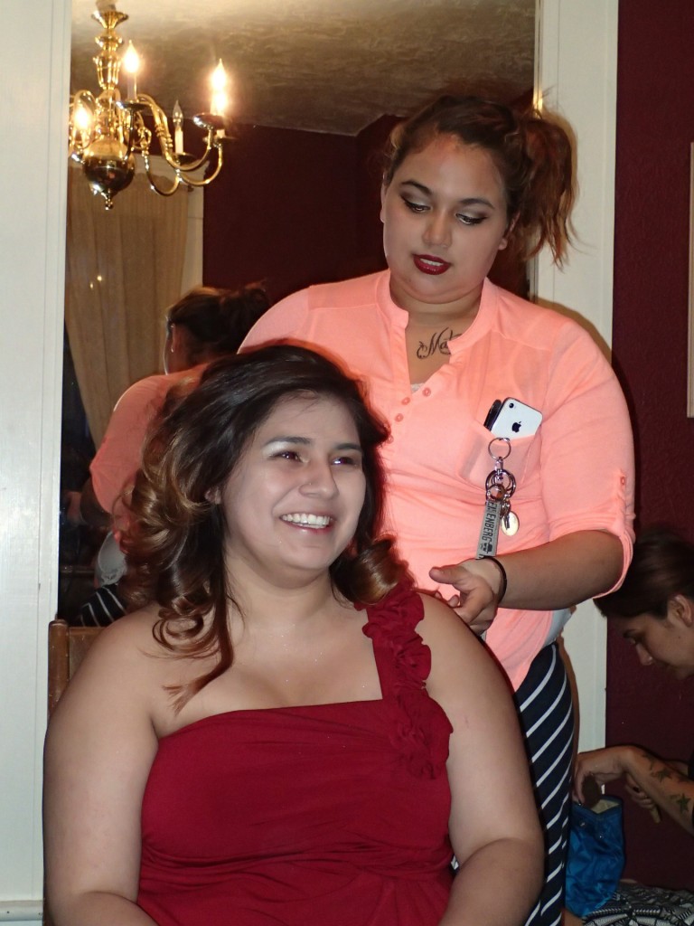 Volunteer stylist Celum Hatch putting finishing curling Isabelle Cervantes'  hair just before prom.Photo: Andrew Gobin/Tulalip News