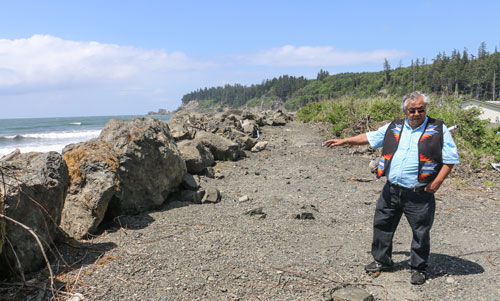 Quinault elder James DeLaCruz Sr. stands by the recently reinforced Taholah seaswall, is among the handful of residents who do not plan to leave the Lower Village during Taholah's relocation. Photo/ Brandi N. Montreuil, Tulalip News