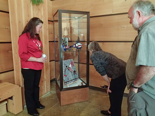 Northwest Indian College Tulalip campus student Monica McAlister discusses her glass mosaic piece featuring a fused glass hummingbird to Northwest Indian College Art Classes exhibit guests. The exhibit is available until August at the Peninsula College's Lonhouse Art Gallery.Photo/ Brandi N. Montreuil, Tulalip News 
