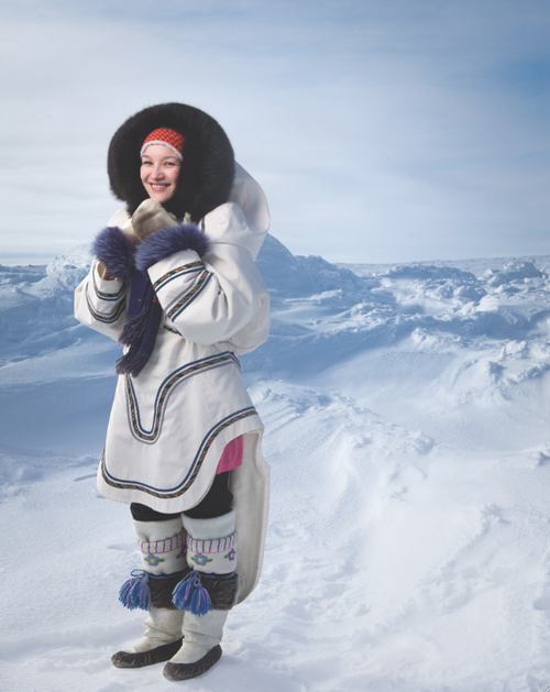 Pallulaaq Friesen models an amauti made by Charlotte St. John; white inner duffles by Saskia Curley; mittens by Shepa Palluq; headband by Pelagie Nicole; kamiks provided by Friesen’s aunt. Photo by Dave Brosha