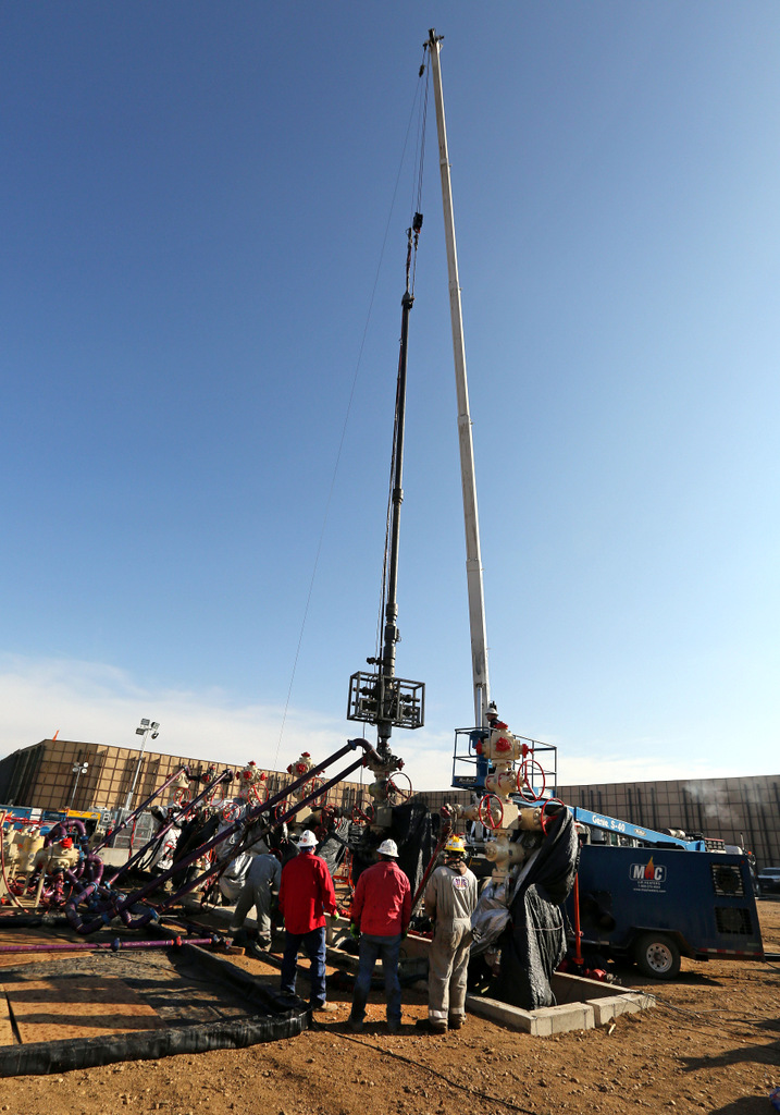 Perforating tools, used to create fractures in the rock, are lowered into one of six wells during a roughly two-week hydraulic fracturing operation at an Encana Corp. well pad near Mead, Colo. (AP/Brennan Linsley)