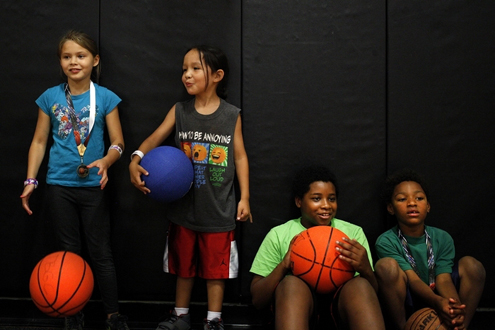 Ian Terry / the heraldFrom left, Georgetta Reeves, 8; Ladainian Kicking-Woman, 6; Tristan Holmes, 11; and Isaiah Holmes, 6, hang out together in the gym at the Tulalip Boys and Girls Club.