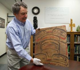 Michael Penn | Juneau EmpireChuck Smythe, director of the History and Culture Department for the Sealaska Heritage Institute, holds a recently acquired wooden panel that appears to be part of an Tlingit bentwood box with a painted Chilkat design. The panel was bought at a contested auction in Paris by the Annenberg Foundation and donated to SHI.