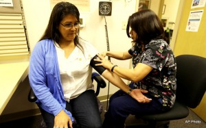 Liz DeRouen, 49, left, gets her blood pressure checked by medical assistant Jacklyn Stra, right, at the Sonoma County Indian Health Project in Santa Rosa, Calif.