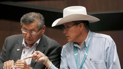 The Navajo Nation will receive $554 million from the U.S. to settle claims of mismanaged funds. Navajo Nation President Ben Shelly, left, talks with tribal presidential candidate Kenneth Maryboy this year. (Ross D. Franklin / Associated Press)