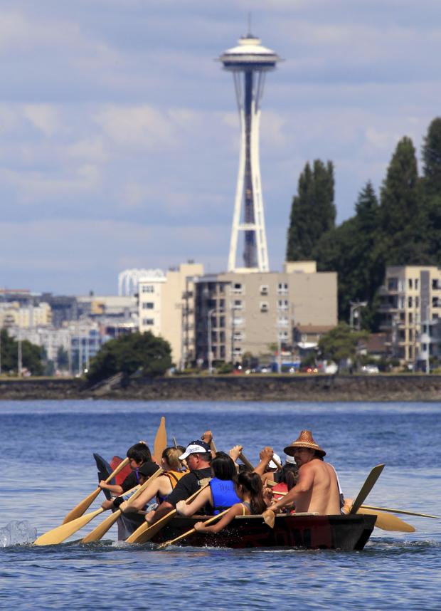 Associated Press photoA tribal canoe, in view of the Space Needle, arrives July 20, 2011, at Seattle’s Alki Beach. The landing of about a dozen canoes marked one leg of an annual journey of tribal canoes from the Salish Sea, heading to Swinomish, Wash.