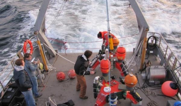 A crew deploying a "sea spider" in 2011 to collect data from the floor of Puget Sound in Admiralty Inlet. After eight years of testing and permitting processes, the Snohomish County PUD has decided to halt the project. | credit: Ashley Ahearn |