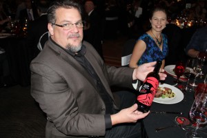 Fresh NW Design has etched the commemorative Taste of Tulalip wine bottle every year. Owner David Olive holds the 2014 commemorative bottle. 
