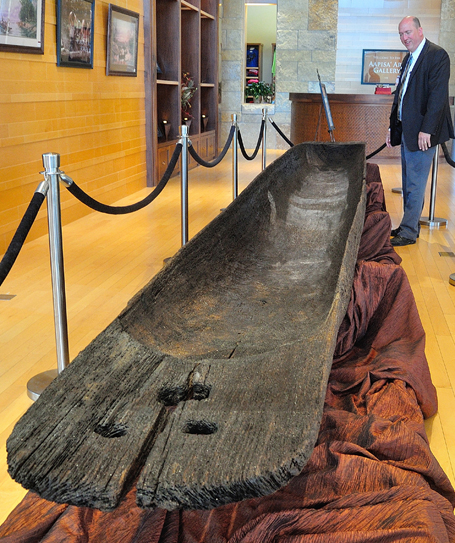 Chickasaw Cultural Center Director of Operations Brad Deramus admires a huge dugout canoe dating to approximately 1500 A.D. It is on loan to the center from the Department of Mississippi Archives and History to augment the world-class Dugout Canoes: Paddling through the Americas currently on display through May 6, 2015, at the Sulphur, Oklahoma, location.