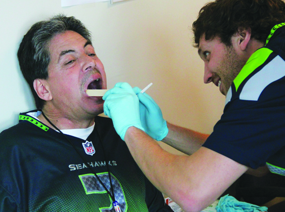  Tribal member Mike Murphy having an oral cancer screening performed.Photo/Micheal Rios