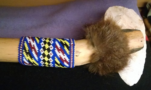 Traditional club staff by Tulalip artist Richard "2 Doggs" Muir is decorated with a tuft of animal fur and a zigzag peyote stitch design. (Tulalip News/ Brandi N. Montreuil) 