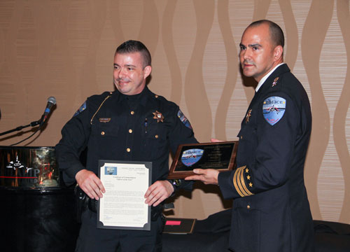 Tulalip Chief of Police Carlos Echevarria presents the  "Officer of the Year" award to K9 officer M.C. Engen and his canine partner Wolfy, Wednesday, Feb. 11, 2015, at the Tulalip Police Department awards banquet held at the Tulalip Resort Casino. (Photo courtesy Theresa Sheldon)