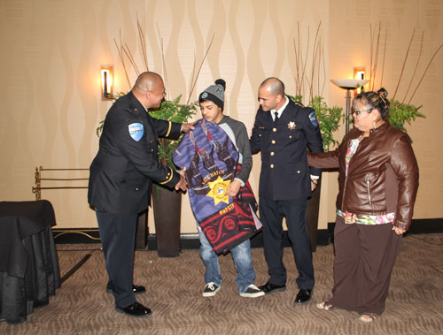 Tulalip Police officer Sherman Pruitt shakes Nate Hatch's hand, Wednesday, Feb 11, 2015, during the Tulalip Police Awards Banquet held at the Tulalip Resort Casino. Hatch was presented the department's "Honoring Our Own" award for his bravery during and after the Oct. 24, 2014 shooting at Marysville High School. He is the only survivor who was shot that day. (Photo courtesy Theresa Sheldon)