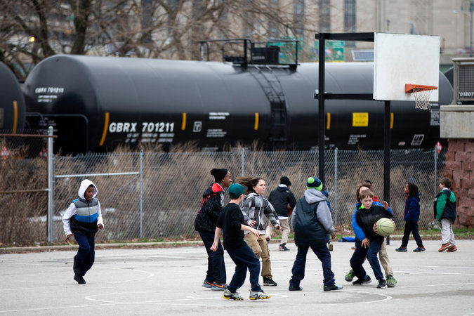 A train with oil tank cars idling in Philadelphia last month. The government has issued updated safety standards, which critics say do too little and the industry says are too strict. 