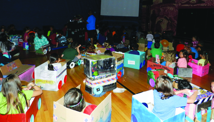 Drive-In Night. The kids worked all week to create their own make-shift cardboard cars so they could go to the drive-in and watch classic cartoons and movies.Photos/Micheal Rios