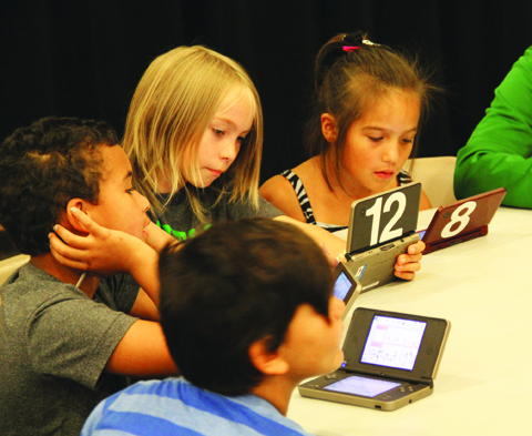 Camp students use a Nintendo DSi tp learn their lines. photo/Micheal Rios