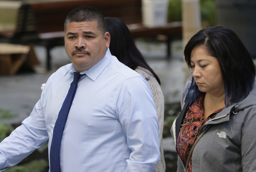 Raymond Fryberg, left, the father of the Washington state teenager who fatally shot four classmates and himself at Marysville-Pilchuck High School in October 2014, arrives at the federal courthouse in Seattle, Monday, Sept. 21, 2015. (AP Photo/Ted S. Warren)