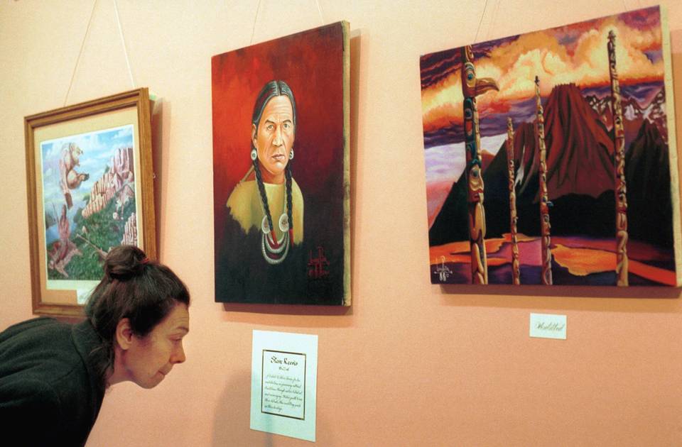 A woman reads a description of Leonard Peltier's oil painting, "Steve Reevis," center on wall in 2001. Peltier is serving two consecutive life terms for the murder of two FBI agents on the Pine Ridge Reservation in South Dakota.A woman reads a description of Leonard Peltier's oil painting, "Steve Reevis," center on wall in 2001. Peltier is serving two consecutive life terms for the murder of two FBI agents on the Pine Ridge Reservation in South Dakota.